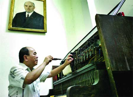 Pitch-perfect: Dang Nguyen Hao fixes a piano Pitch-perfect: Dang Nguyen Hao fixes a piano