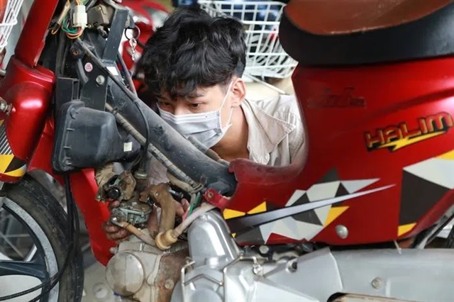 Gen Z student repairing dorm motorbikes for free